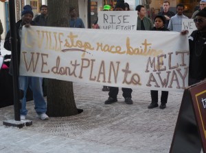 Protesters held up a banner referring to an editorial comment made by Cville Weekly editor Giles Morris.